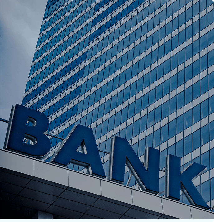 Outside image zooming in on letters “bank” in front of a skyscraper in Denver.