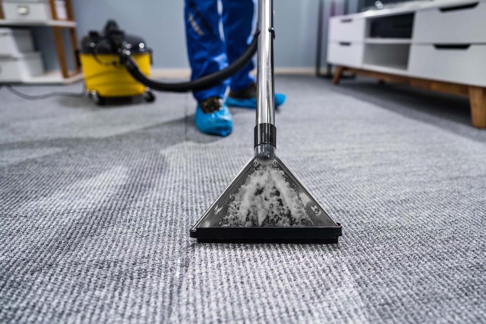Commercial cleaner cleaning an industrial carpet.